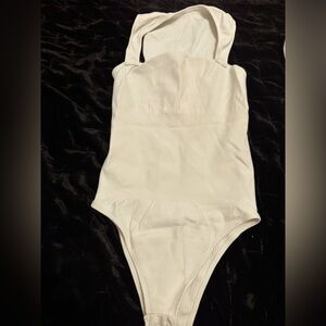 White Minimalist Bodysuit with High-Cut Design